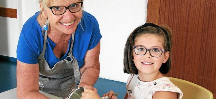 Erell était ravie, ce mercredi 18 septembre, de découvrir les techniques de la peinture sur différents supports dispensés par Kathy Le Noc, Riécoise. © Le Télégramme